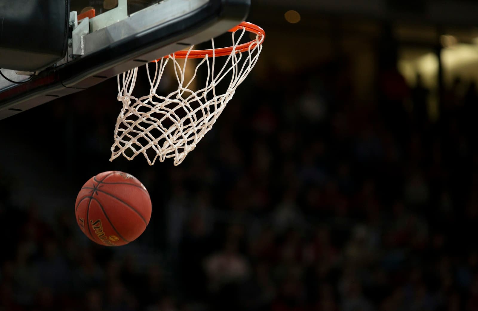 Basketball approaching the hoop in an indoor arena